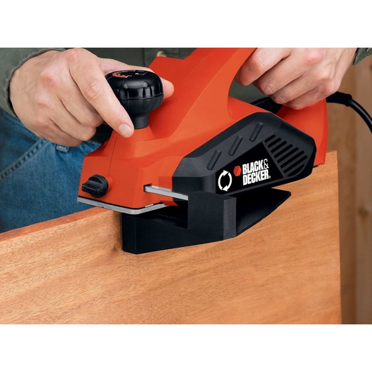 5.2 Ampere planer being used by a person to smooth out wooden edges.