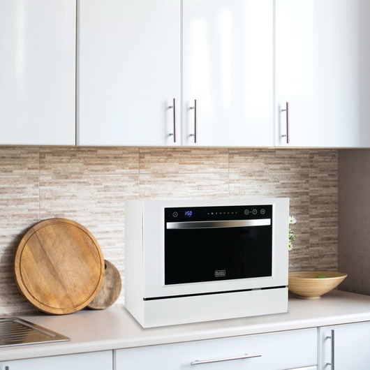 Profile of 6 place setting compact countertop dishwasher.