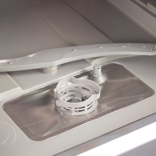 Profile of easy to clean filter in a 6 place setting compact countertop dishwasher.