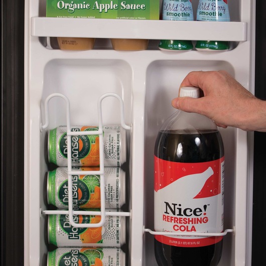 Inside of  2 and a half cubic foot Energy Star Refrigerator with Freezer filled with various soda cans and bottles.