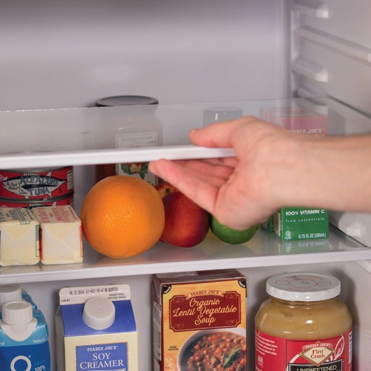 2.5 cu ft energy star refrigerator with freezer V C M being used to store food.