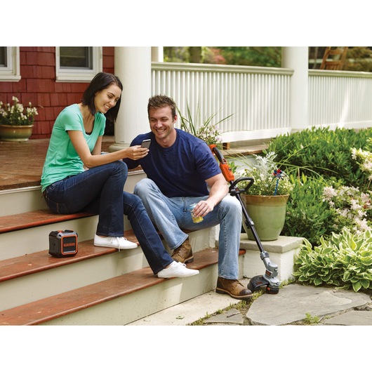 20 volt MAX wireless bluetooth speaker with AC power being placed on wooden stairs.