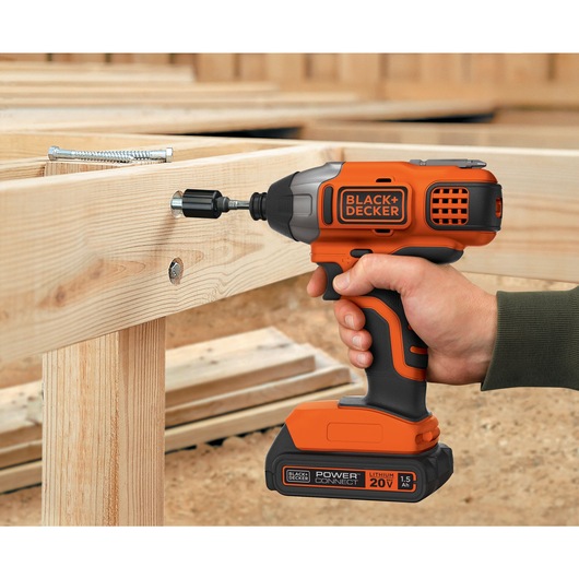 MAX Lithium Impact Driver being used to drive screw in wooden frame.