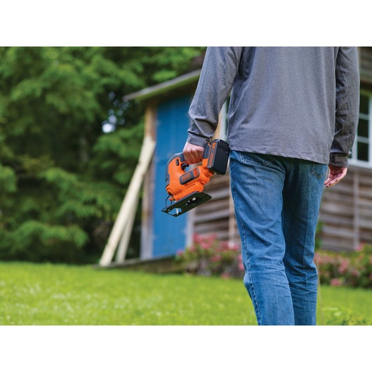 Cordless Jigsaw being carried by person with single hand.
