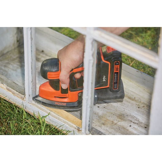 MAX MOUSE Cordless Sander being used to refinish wooden frame structure.