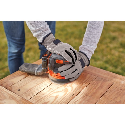 Cordless Random Orbital Sander being used to sand wood.