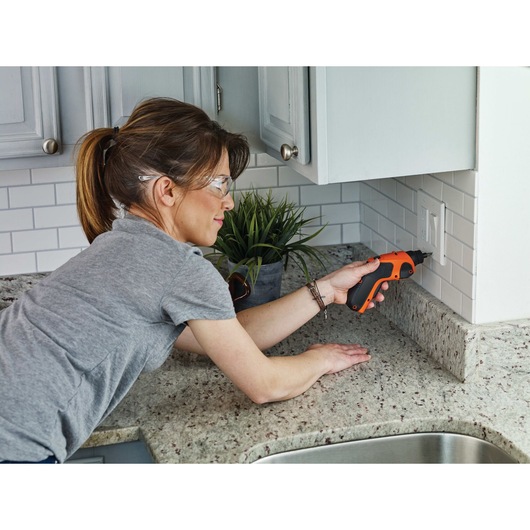 4 volt max lithium rechargeable screwdriver being used to screw in a switch.