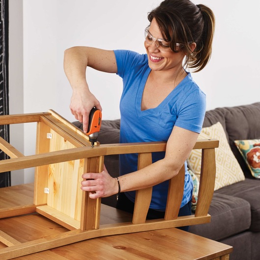 4 volt MAX Lithium Rechargeable Screwdriver being used to drill nails in a chair.