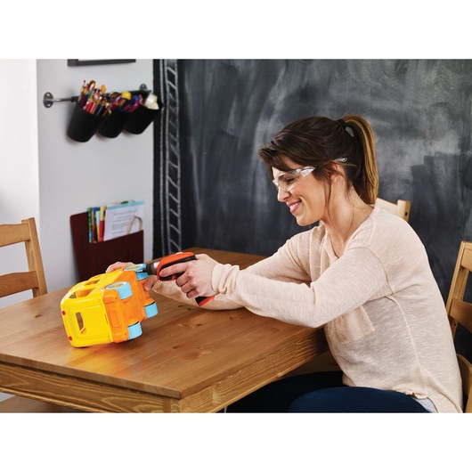 4 volt MAX lithium rechargeable screwdriver being used by a person to assemble a toy bus.
