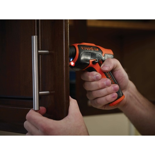 4 Volt ROTO BIT Storage Screwdriver being used on cabinet handle.