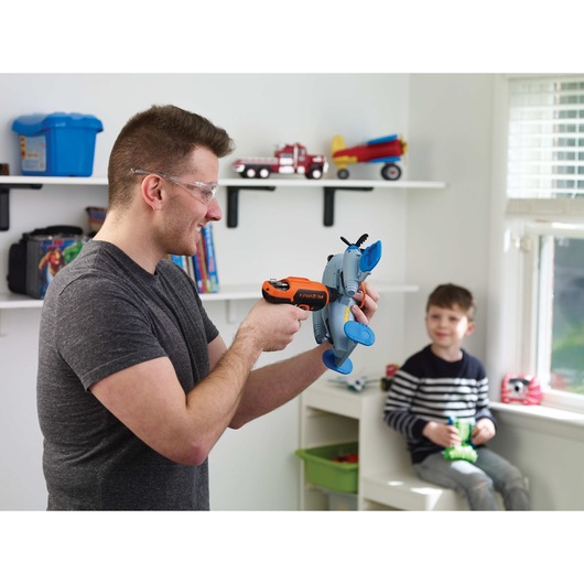 4 volt MAX ROTO BIT storage screwdriver being used by a person to fix toy aeroplane.