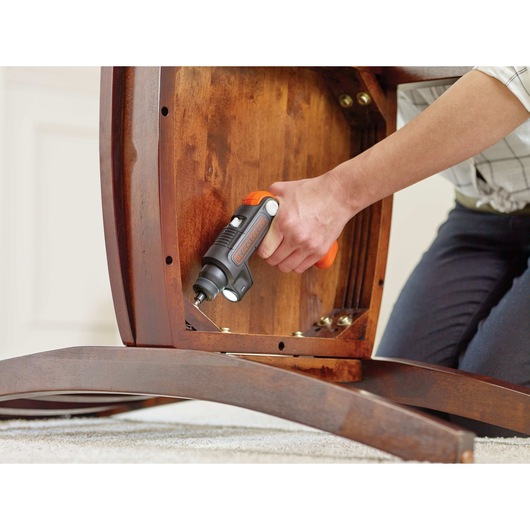Lithium ion light driver cordless screwdriver driving screw in chair.