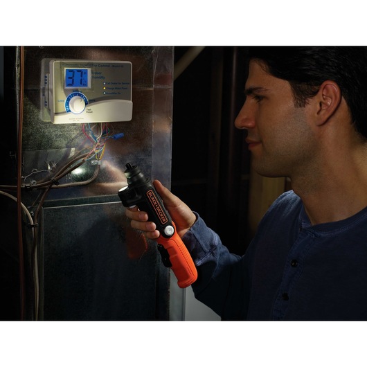 Lithium Ion Light Driver Cordless Screw driver being used by person to light up wires to work.