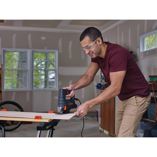 4 A Corded Jigsaw being used for cutting plywood.