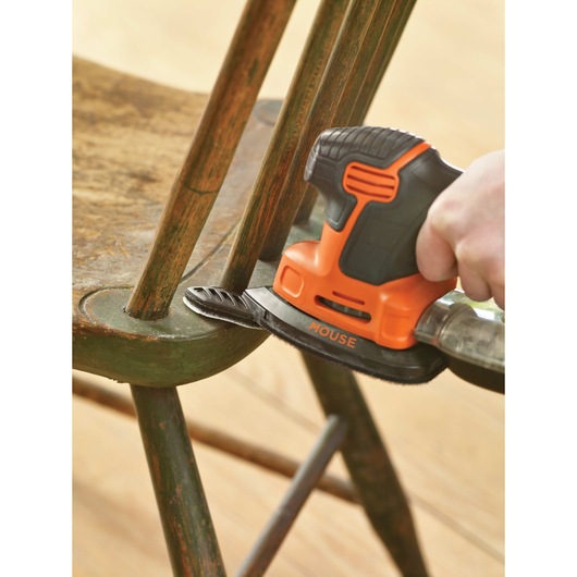 Mouse detail sander being used on a chair.
