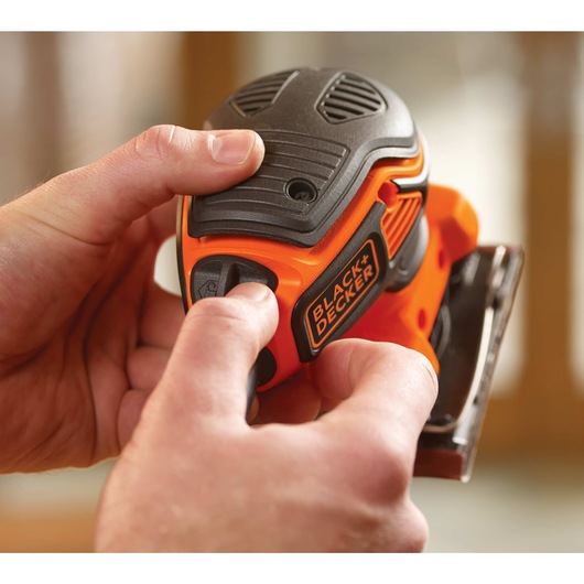 Paddle switch feature of one fourth sheet orbital sander with paddle switch actuation.