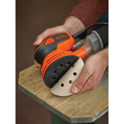 Peelable sander blade cover feature of a 5 inch random orbital sander.