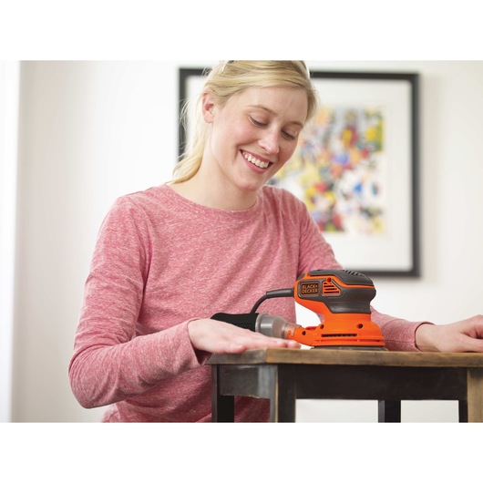 5 inch Random Orbital Sander used for sanding wooden side table.
