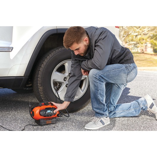 20 volt multi purpose inflator being used by a person.