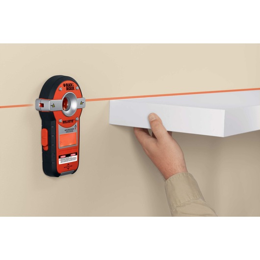 Bullseye auto leveling laser with stud sensor being used .