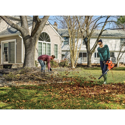 Overhead view of 3 in 1 vacpack 12 amp leaf blower vacuum and mulcher being used by a person to vacuum leaves.