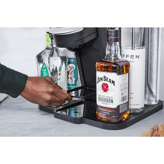 close-up, in the kitchen, of a man's releasing the glass shelf from the bev by BLACK+DECKER™ cocktail maker