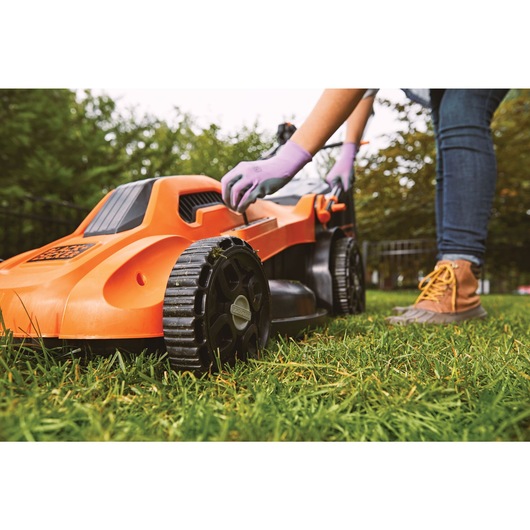 Height adjust feature of 13 ampere 20 degree corded electric lawn mower.
