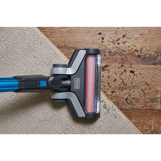 Powerseries extreme cordless stick vacuum cleaner being used to clean floor.