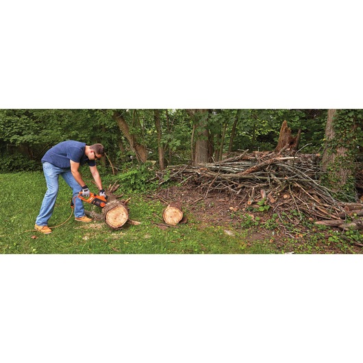 12 Amp 16 inch Chainsaw being used to cut tree trunk.