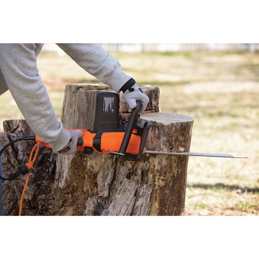 Chainsaw cutting tree.

