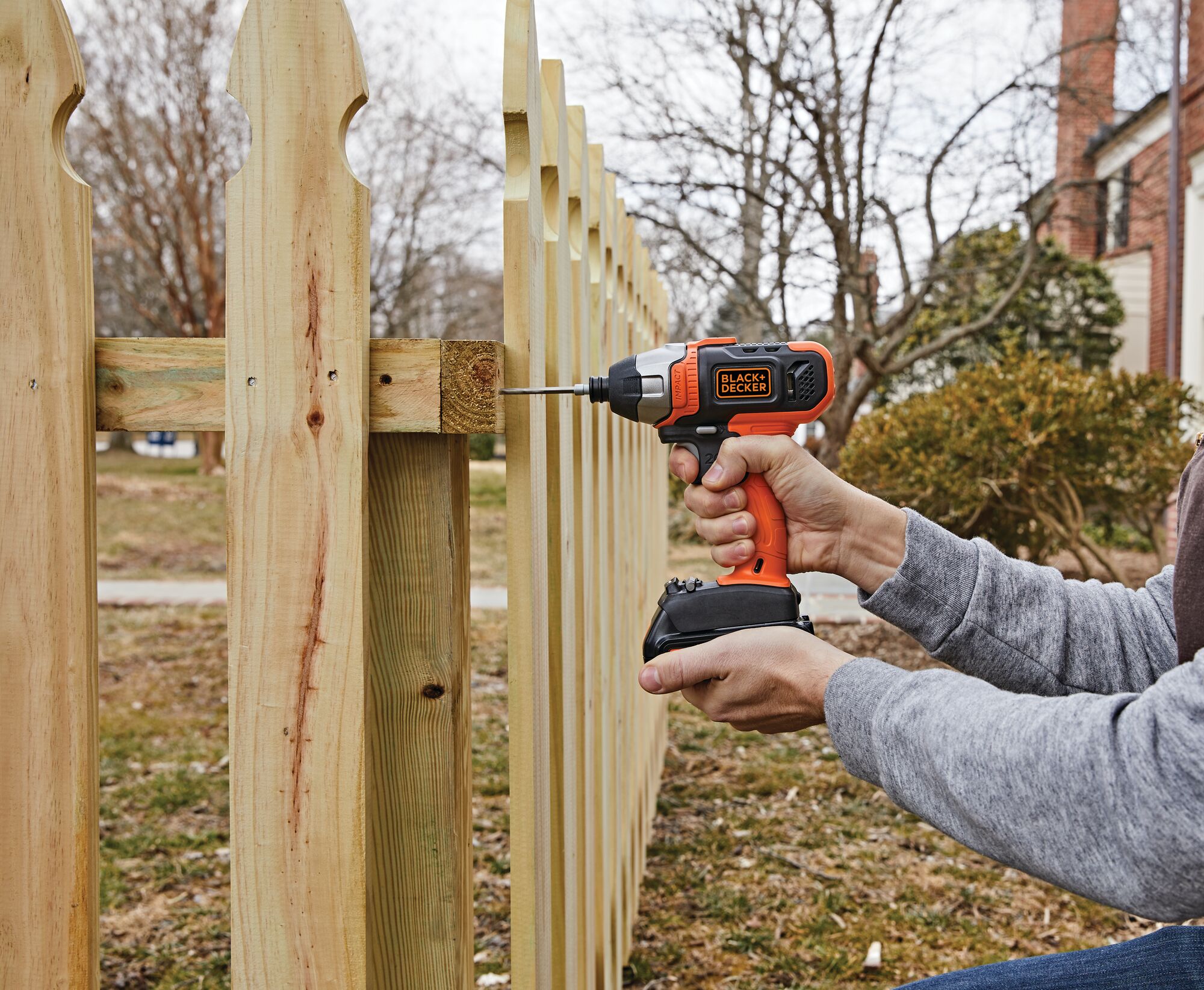 Cordless Impact Driver being used for fixing wooden fence.