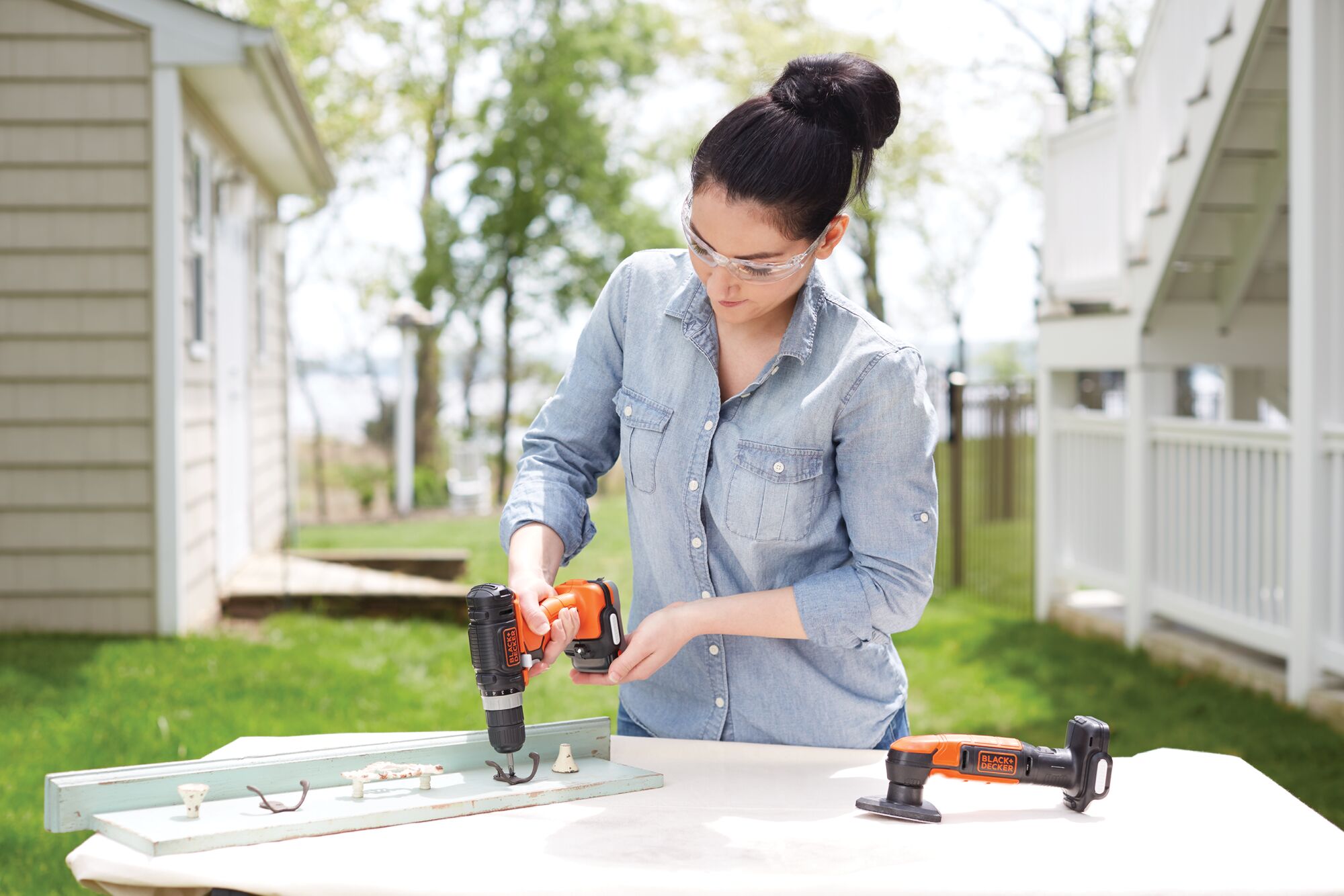 GoPak 4 tool combo kit being used by a person to fix drawer handles.