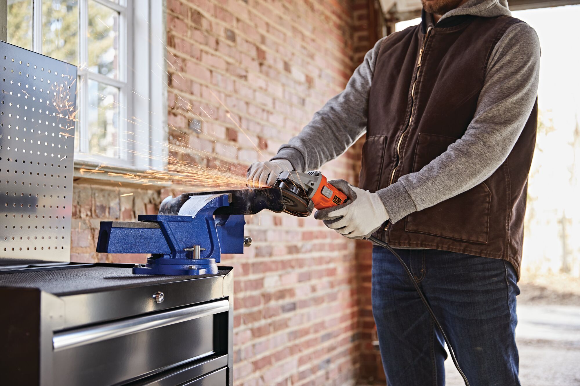 6.2 amp small angle grinder being used to grind a metal piece.