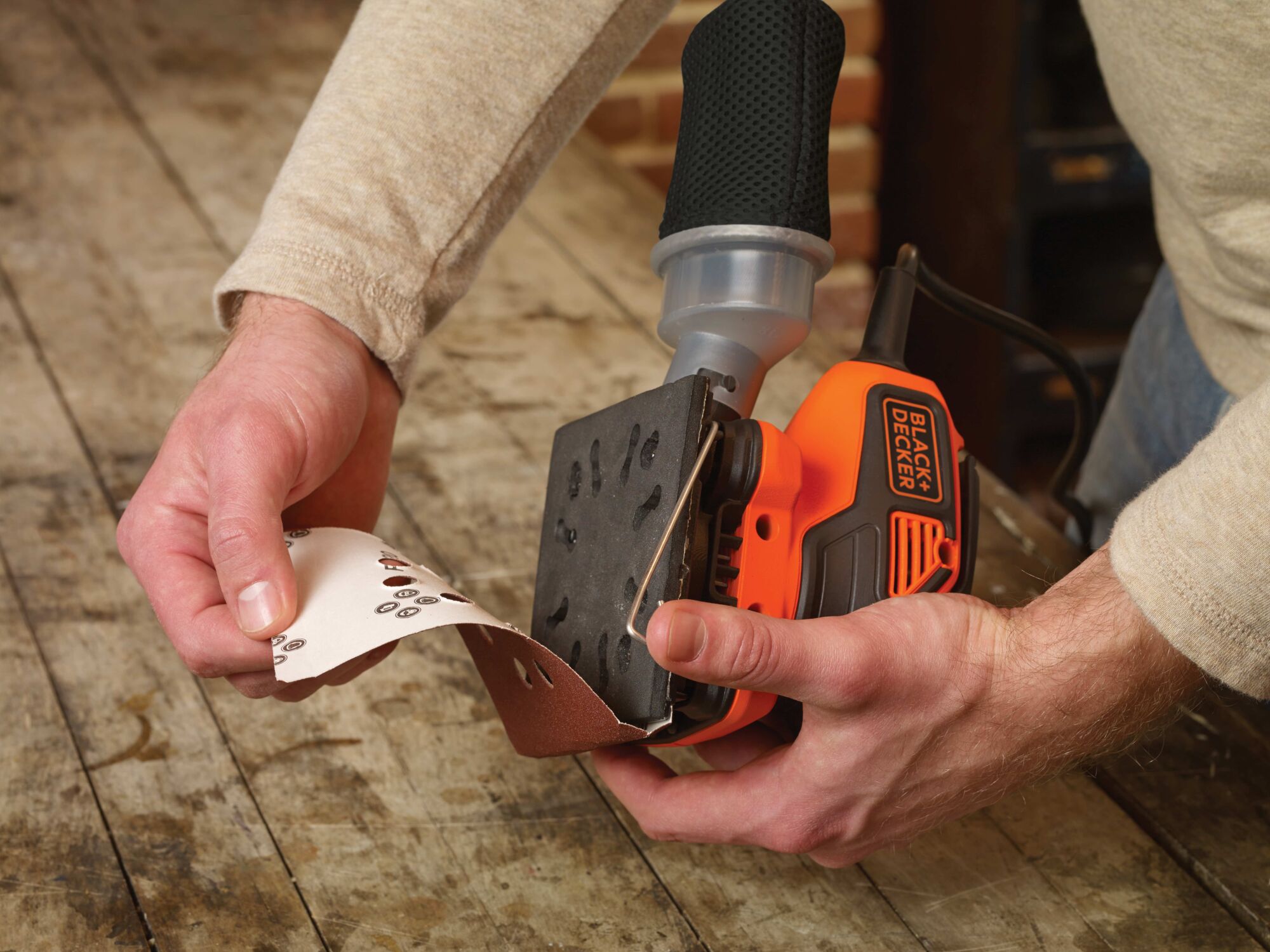 Changeable sandpaper feature of a quarter sheet orbital sander with paddle switch actuation.