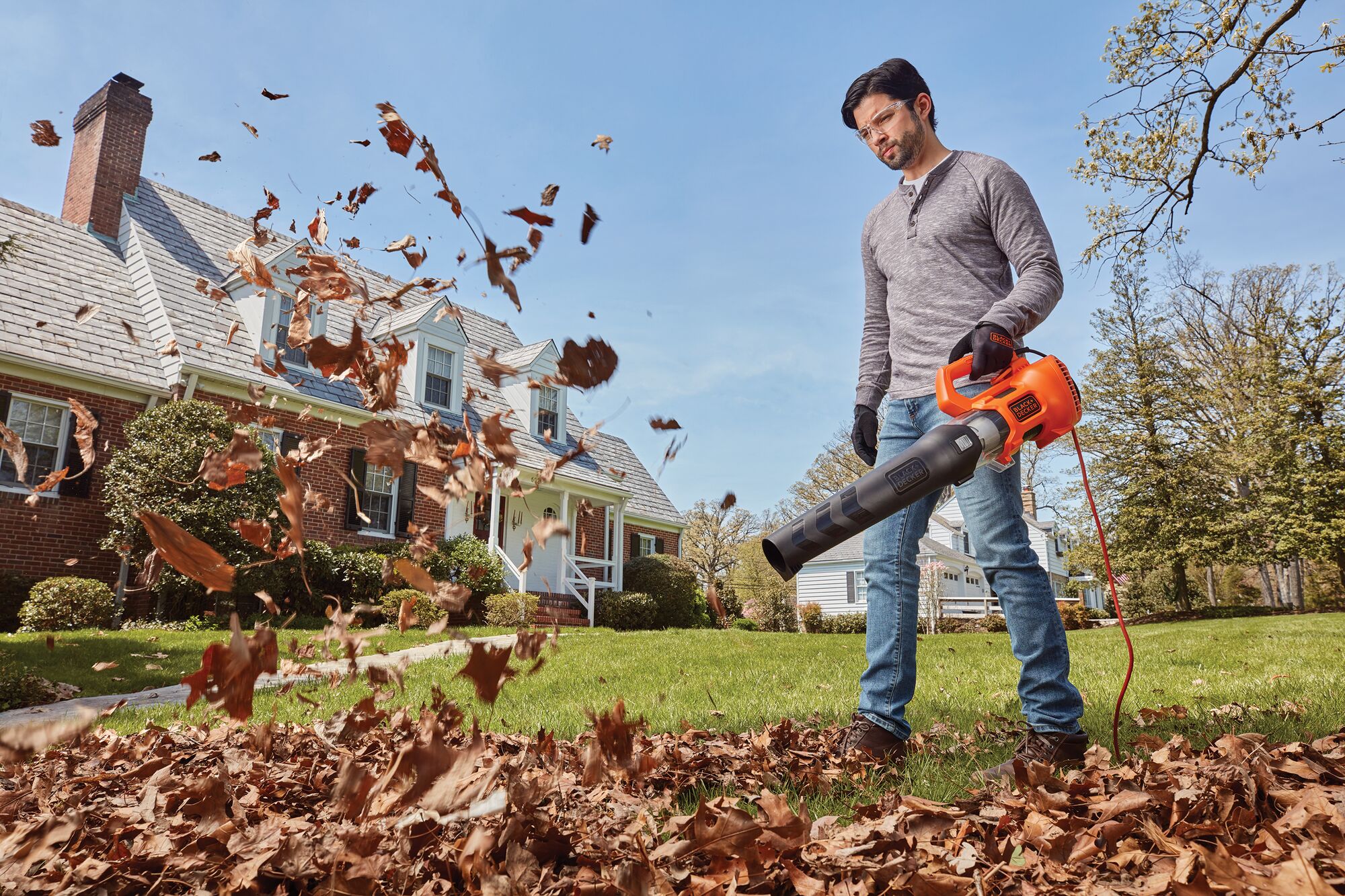 9 ampere electric axial leaf blower being used by a person.