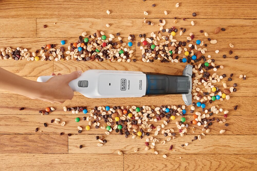 Dust buster 12 Volt Advanced Clean Cordless Hand Vacuum being used on floor.
