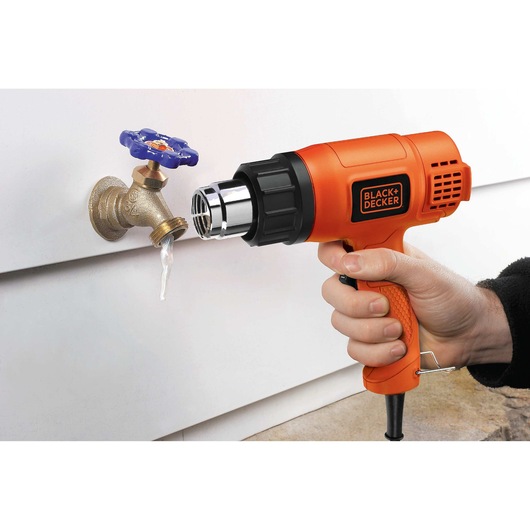 Dual Temperature Heat Gun being used to melt frozen water in tap.