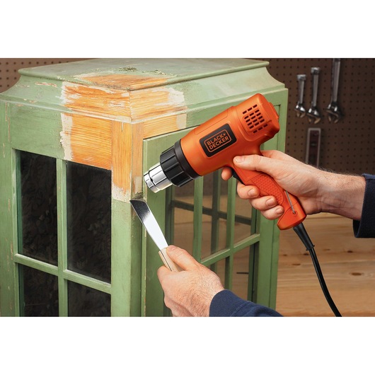 Dual temperature heat gun being used.