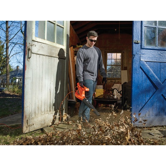 7 Amp Blower being used by person to blow leaves.
