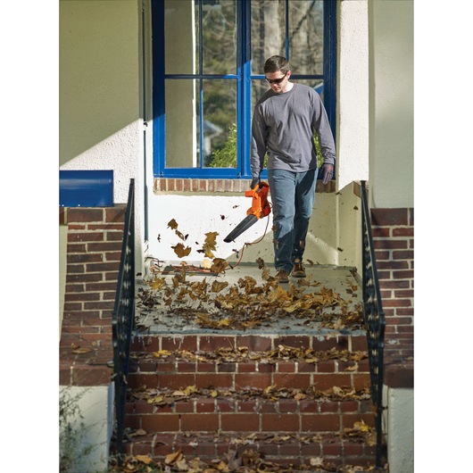7 amp blower being used by a person.