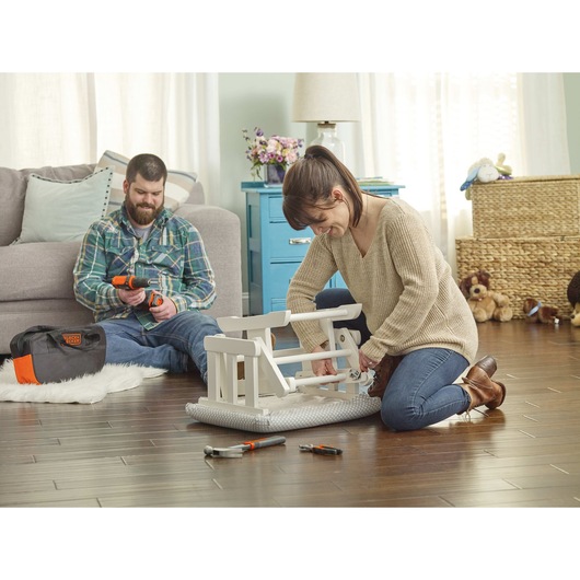 20 volt max lithium ion drill/driver plus 68 piece project kit being used by a person.