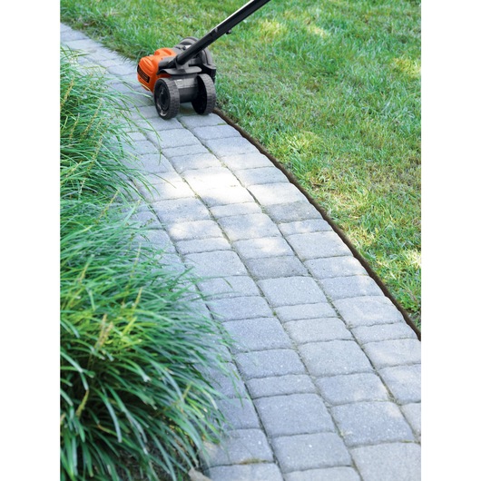 2 in 1 Landscape edger and trencher edging along sidewalks.