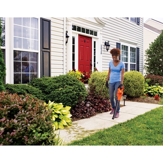20 Volt Lithium Sweeper being used by a person in a garden.