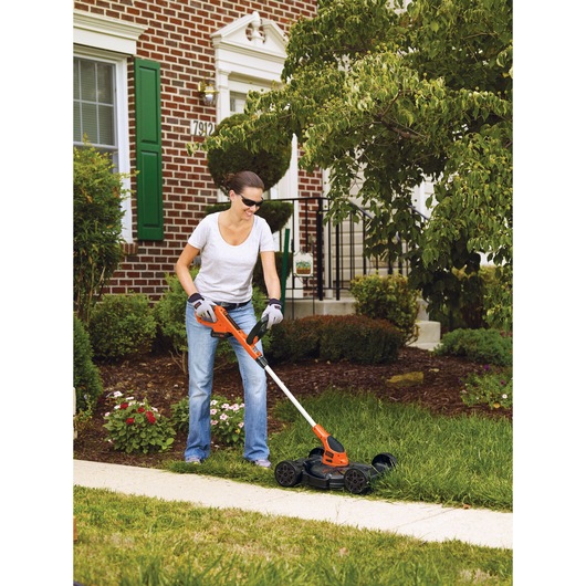 Lithium 12 inch 3 in 1 Compact Mower being used to cut grass.
