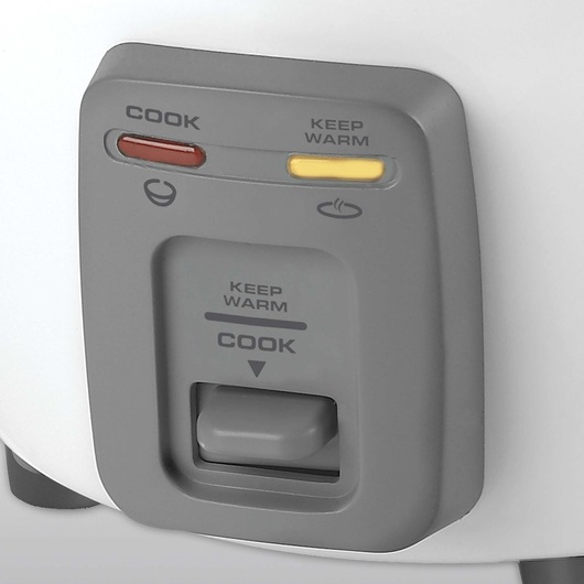 Close up of cook and warm indicator lights of 3 Cup Dry or 6 Cup Rice Cooker and Steamer.